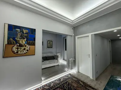 a living room with a couch and a painting on the wall at Dolce Vita House - 10min walk to Vatican in Rome