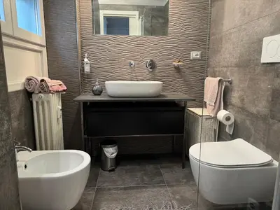 a bathroom with a sink and a tub and a toilet at Dolce Vita House - 10min walk to Vatican in Rome
