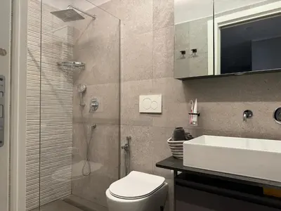 a bathroom with a shower and a toilet and a sink at Dolce Vita House - 10min walk to Vatican in Rome