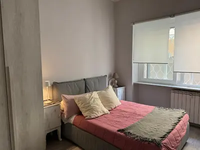 a bedroom with a bed with a red blanket and a window at Dolce Vita House - 10min walk to Vatican in Rome