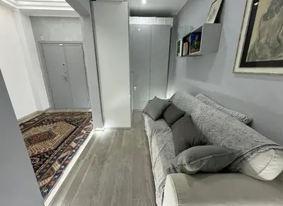 a living room with a couch and a rug at Dolce Vita House - 10min walk to Vatican in Rome