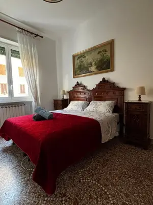 a bedroom with a large bed with a red blanket at Vodice Apartment- Between Vatican and Foro Italico in Rome