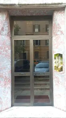 a building with a glass door with cars in it at Vodice Apartment- Between Vatican and Foro Italico in Rome