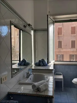 a bathroom with a tub and a mirror and a sink at Vodice Apartment- Between Vatican and Foro Italico in Rome