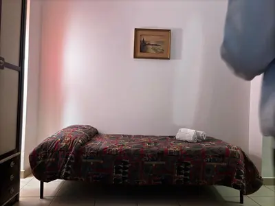 a bed in a room with a blanket on it at Vodice Apartment- Between Vatican and Foro Italico in Rome