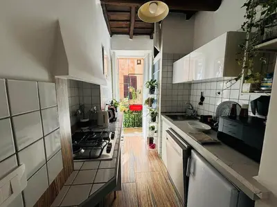 a kitchen with a stove and a counter top at Scala 31 Trastevere in Rome