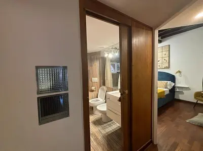 a bathroom with a toilet and a bathroom with a sink at Scala 31 Trastevere in Rome