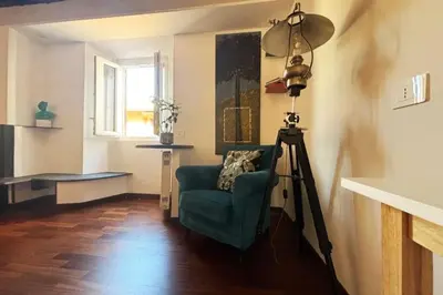 a camera in a room with a chair and a tripod at Scala 31 Trastevere in Rome