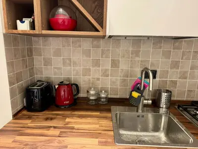 a kitchen counter with a sink and a stove at Trastevere Cozy Retreat in Rome