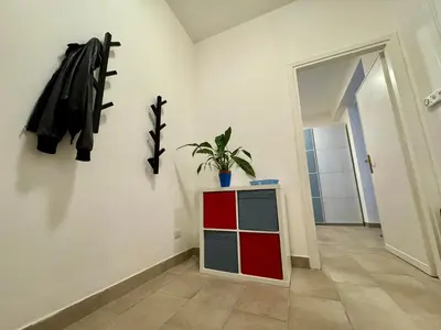 a room with a red cabinet and a plant on a wall at Trastevere Cozy Retreat in Rome