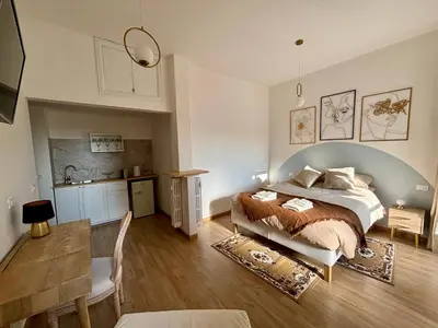 a bedroom with a large bed and a kitchen at Living Rome Flaminio - Appartamento parziale - Alloggio ad uso turistico in Rome