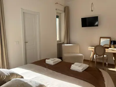 a bedroom with a bed with a chair and a desk at Living Rome Flaminio - Appartamento parziale - Alloggio ad uso turistico in Rome
