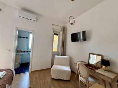 a room with a table and a chair and a desk at Living Rome Flaminio - Appartamento parziale - Alloggio ad uso turistico in Rome