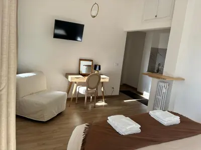 a room with a bed and a table and a chair at Living Rome Flaminio - Appartamento parziale - Alloggio ad uso turistico in Rome