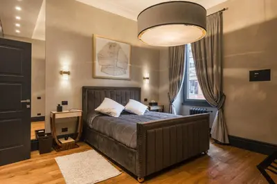 a bedroom with a bed and a large lamp at Mega Royal Suite in Rome