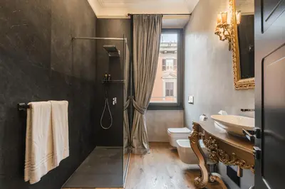 a bathroom with a shower and a sink and a toilet at Mega Royal Suite in Rome