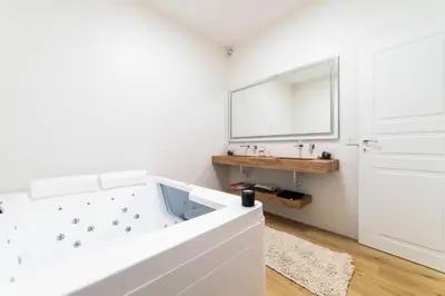 a white bathroom with a tub and a sink at Vatican Home 168 in Rome