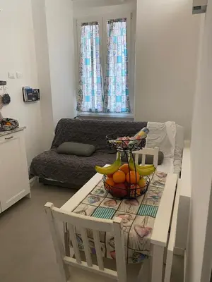 a kitchen with a table with a bowl of fruit on it at Il diamante del Colosseo in Rome