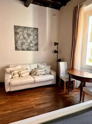 a living room with a white couch and a table at Tata Home Monti in Rome
