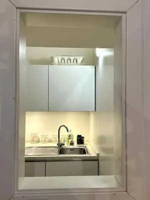 a kitchen with a sink and white cabinets at Tata Home Monti in Rome