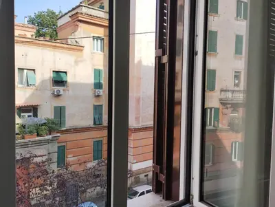 an open window with a view of a building at La Casetta di Nonna Ro al Testaccio in Rome