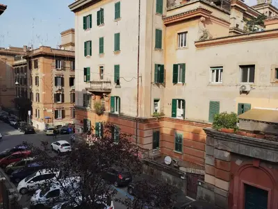 a view of a city with cars parked in front of buildings at La Casetta di Nonna Ro al Testaccio in Rome