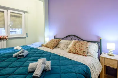 a bedroom with a large bed with blue sheets and pillows at 