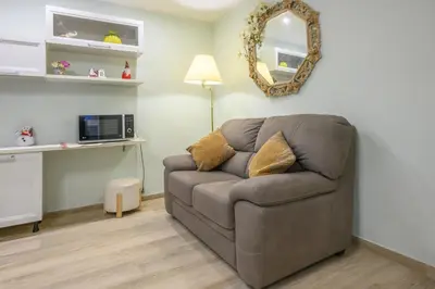 a living room with a couch and a mirror at 