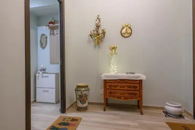 a room with a mirror and a table and a refrigerator at 