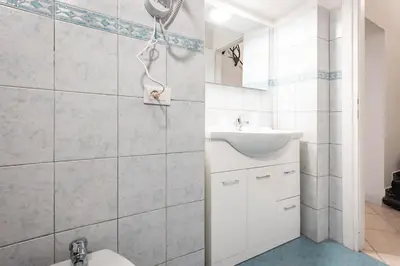 a white bathroom with a sink and a toilet at MichaelHouse in Rome
