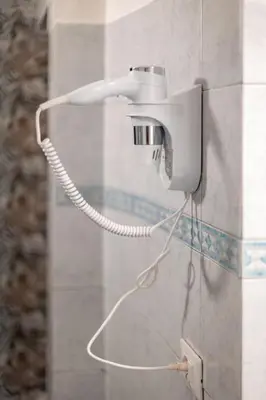a phone on a wall with a cord plugged into it at MichaelHouse in Rome