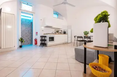 a large kitchen and living room with a table and chairs at MichaelHouse in Rome