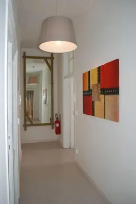 a hallway with a mirror and a painting on the wall at Affitti brevi Colosseo 2 in Rome