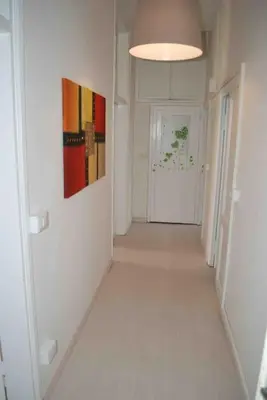 an empty hallway with a door and a painting on the wall at Affitti brevi Colosseo 2 in Rome