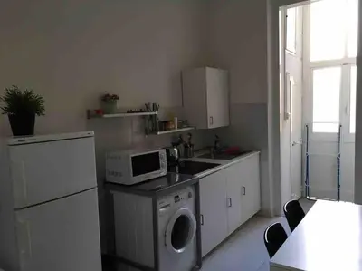 a kitchen with a washing machine and a microwave at Affitti brevi Colosseo 2 in Rome