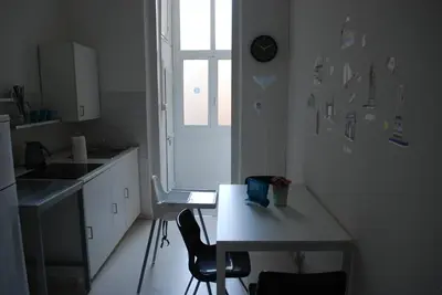 a small kitchen with a table and a table and a window at Affitti brevi Colosseo 2 in Rome