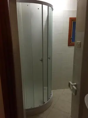 a shower with a glass door in a bathroom at Affitti brevi Colosseo in Rome