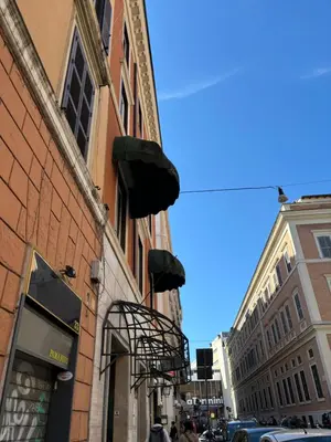 a street with a building with a fire escape at Affitti brevi Colosseo in Rome