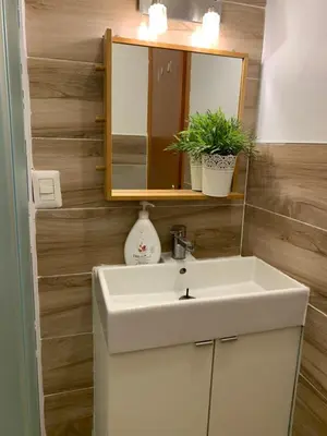 a bathroom with a white sink and a mirror at Affitti brevi Colosseo in Rome