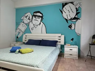 a bedroom with a bed with a painting on the wall at Camere artistiche in appartamento in Rome