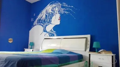 a bedroom with a blue wall with a woman painted on it at Camere artistiche in appartamento in Rome