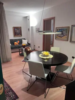 a dining room with a black table and chairs at Sweet Home Cavalese, Cortina d'Ampezzo, Università Cattolica, Gemelli in Rome
