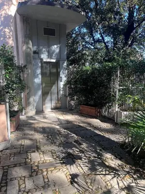 a house with a gate and a stone patio at Sweet Home Cavalese, Cortina d'Ampezzo, Università Cattolica, Gemelli in Rome