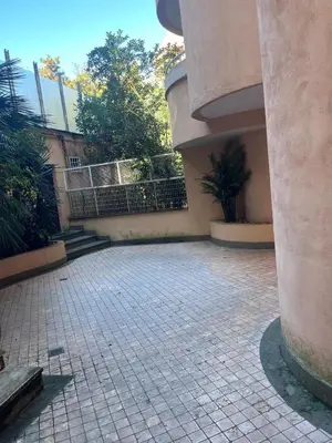 a courtyard with a building with a fence and stairs at Sweet Home Cavalese, Cortina d'Ampezzo, Università Cattolica, Gemelli in Rome
