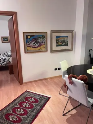 a living room with a table and chairs at Sweet Home Cavalese, Cortina d'Ampezzo, Università Cattolica, Gemelli in Rome