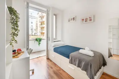a bedroom with a bed and a window at Trieste Home! in Rome