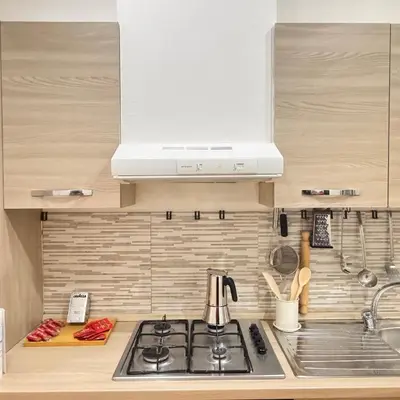 a kitchen with a stove top and a microwave at Trieste Home! in Rome