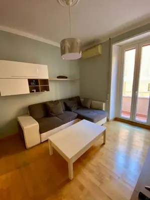 a living room with a couch and a coffee table at Lovely Apartment near metro A Re di Roma in Rome