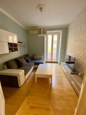 a living room with a couch and a table at Lovely Apartment near metro A Re di Roma in Rome