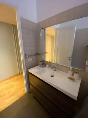 a bathroom with a sink and a mirror at Lovely Apartment near metro A Re di Roma in Rome